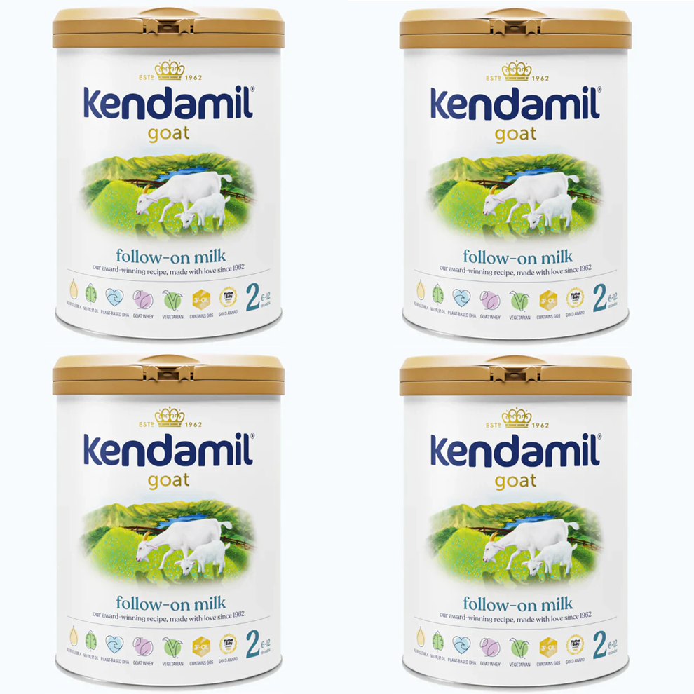 Four containers of Kendamil goat follow-on milk on a white background
