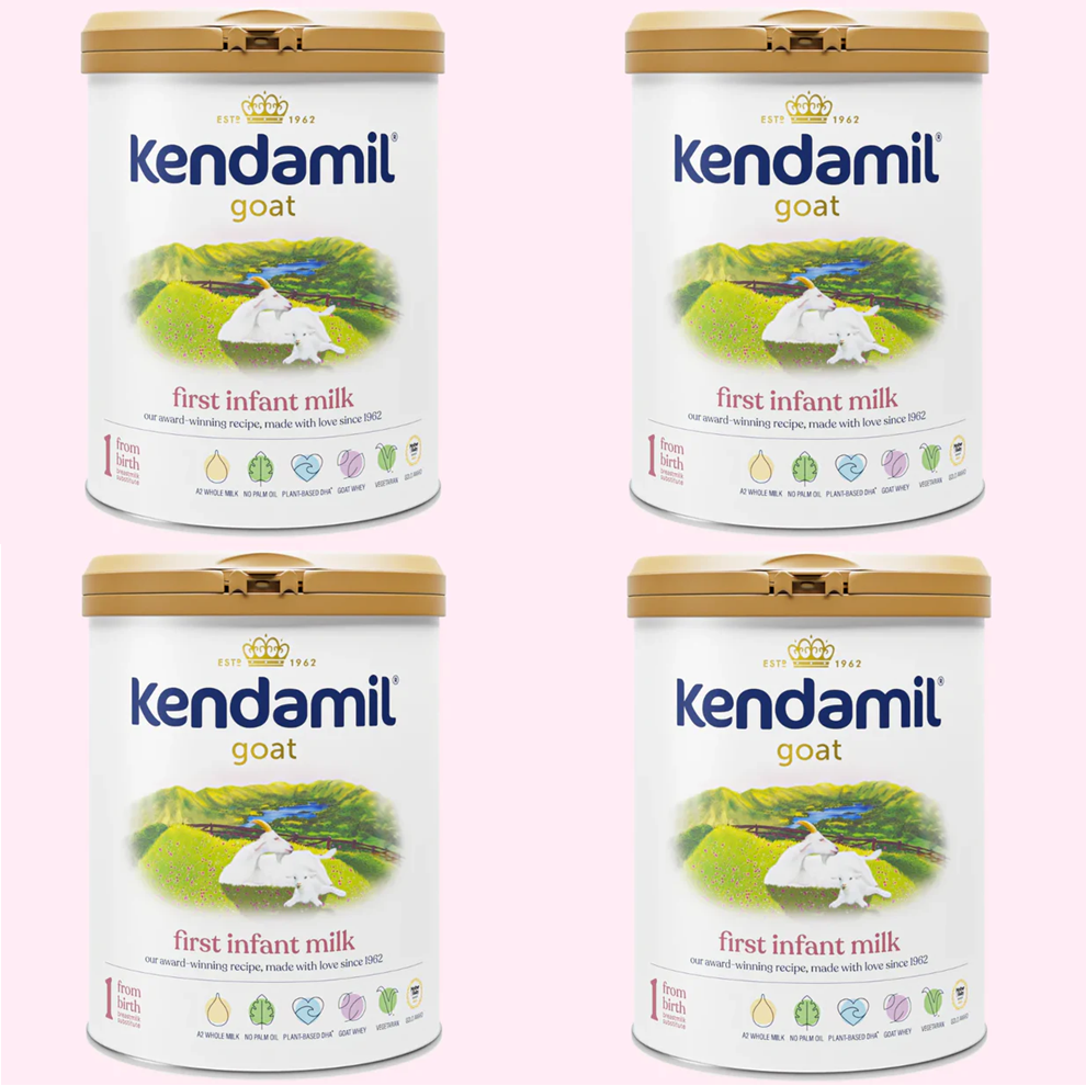 Four tins of Kendamil goat first infant milk on a white background